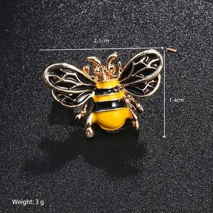 Macro detail of bee enamel brooch showing dimensions 2.1cm by 1.4cm and 3g weight