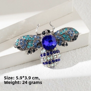 Detail view of blue rhinestone bee brooch with dimensions 5.9x3.9cm and 24g weight