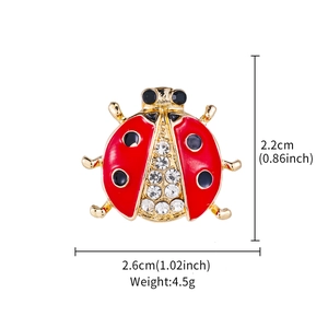 Detail view of ladybug enamel brooch showing 2.2cm height and 2.6cm width dimensions
