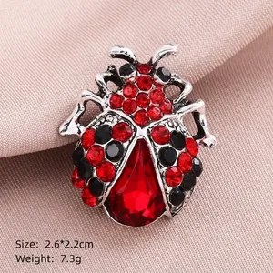 Red ladybug beetle brooch with silver base and sparkling rhinestones for clothing