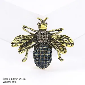 Blue rhinestone bee brooch in gold alloy finish, dimensions 3.3cm by 4cm for clothing decor