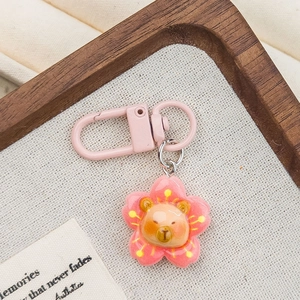 Pink sakura flower keychain with cute cartoon bear head and matching metal D-ring clasp