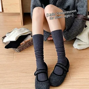 Dark grey cashmere calf socks with ribbed knit design and slimming micro-compression effect