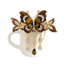 Elegant gold butterfly hair claw clip with amber wings and dangling tassel chains