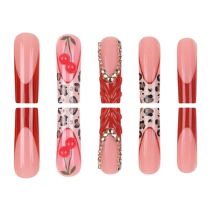 Red French press-on nails with leopard print, 3D cherry designs and rhinestone accents