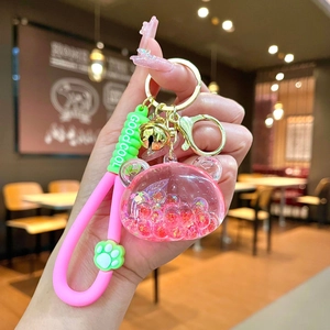 Rosa Bär-Schlüsselanhänger mit flüssigem Glitzer, Katzenpfote und grünem Armband