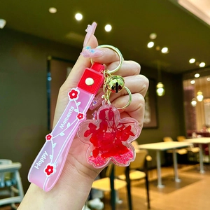 Creative floral oil-filled liquid keychain with dried flowers and pink silicone strap
