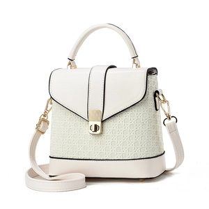 Chic cream white top-handle crossbody bag with woven texture and gold twist lock