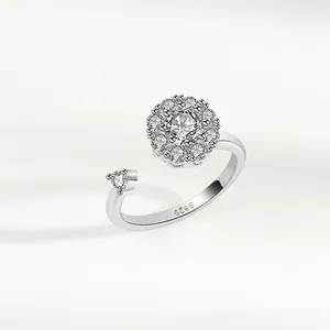 Detail of adjustable S925 silver spinner ring featuring a sparkling zircon flower design