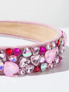 Macro shot of pink velvet headband featuring encrusted colorful crystal hearts