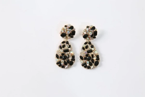 Detail of tear-drop earrings featuring AB rhinestones and black faceted crystals on gold base