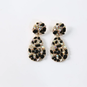 Exaggerated retro gold drop earrings with black faceted gems and iridescent rhinestones