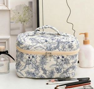 Quilted cotton cosmetic bag with vintage blue floral prints and sturdy handle detail