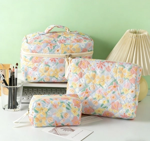 Three-piece quilted cotton floral toiletry bags set for makeup storage in various sizes