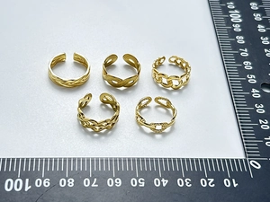 Detailed top view of five adjustable 18K gold-plated stainless steel rings with size ruler