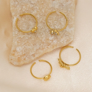 Four-piece set of 18K gold plated adjustable rings with heart, rose and knot designs