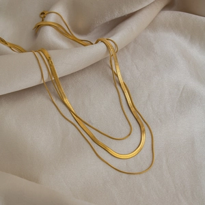 Three-layer layered gold snake chain necklace in minimalist titanium steel on silk