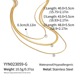 Detailed view of triple-layered gold stainless steel snakeskin and flat chain necklaces