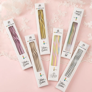Macro shot of 6-piece spiral metallic birthday candles in a premium window gift box