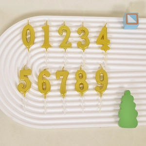 Detailed top view of gold number candles from 0 to 9 with sticks for birthday cake