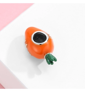 Macro detail of S925 sterling silver carrot charm with orange and green enamel finish