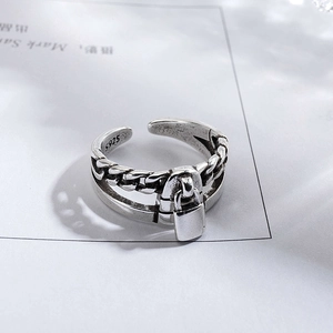 Macro shot of S925 sterling silver vintage chain ring with small lock pendant detail