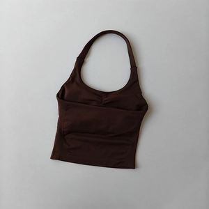 Detail of chocolate brown halter neck sports bra with seamless ribbed fabric and ruched chest