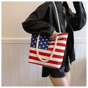 Detail of canvas tote bag featuring US flag pattern and thick cotton rope handles