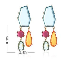 Détail de boucles d'oreilles géométriques avec cristaux multicolores et base métal
