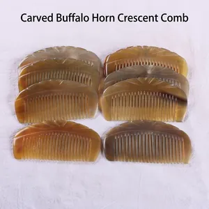 Natural ox horn half-moon comb with detailed carvings and smooth rounded teeth