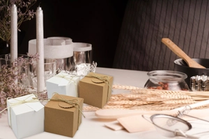 Detail of square kraft paper gift box with twine ribbon and round lid closure