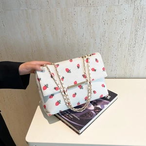Off-white corduroy shoulder bag with red strawberry print and golden chain strap