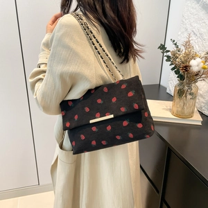 Fashionable black corduroy shoulder bag with red strawberry patterns and chain strap
