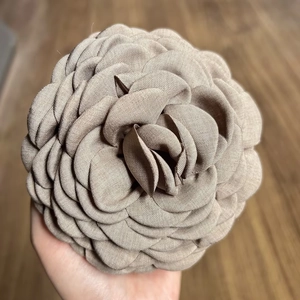 Detailed close-up of a handmade khaki fabric rose hair claw clip with vintage texture