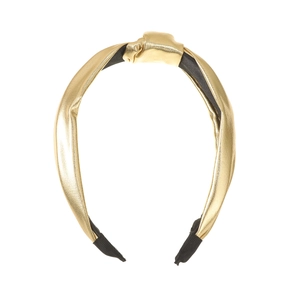 Detail of golden metallic knot headband showing textured finish and black fabric ends