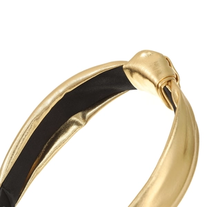 Close-up of golden metallic knot headband with shiny PU leather and black lining texture