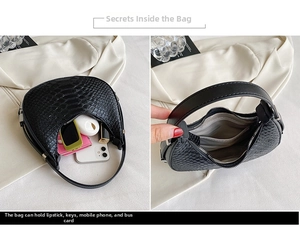 Detail view of the interior capacity showing a black crocodile-texture crescent bag