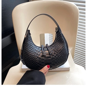 Detail of black crocodile pattern hobo bag with dual zipper and silver hardware