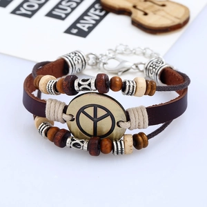 Detail of multi-layer leather bracelet with peace sign charm and wooden beads