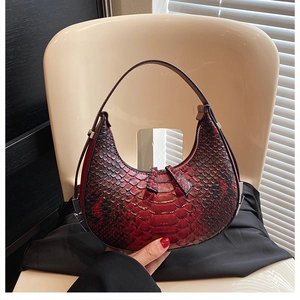 Detailed close-up of dark red hobo bag with embossed crocodile texture on white chair