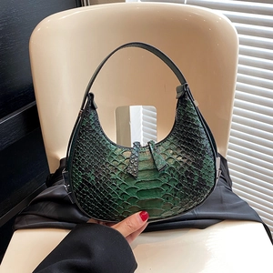 Green and black snakeskin pattern hobo shoulder bag with a crescent shape and metal zipper