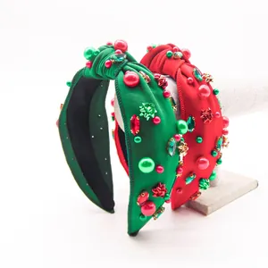 Detail of velvet Christmas headbands with festive knot and colorful rhinestone embellishments