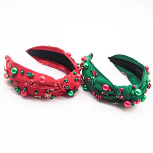 Detail of red and green knotted headbands with rhinestones, pearls and mini bows