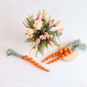 Easter farmhouse decoration featuring three tiered orange wood bead carrot garlands with tassels