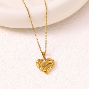 Minimalist heart pendant necklace in 18K gold finish with textured lava surface and fine chain