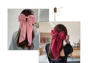 Close-up of elegant solid color chiffon bow hair clips with long flowing ribbons