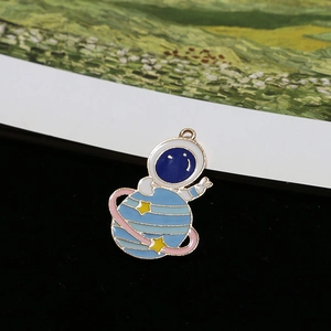 Detail of creative blue astronaut enamel charm with yellow star for DIY jewelry crafts