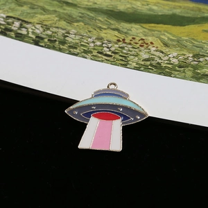 Macro detail of colorful enamel UFO pendant with striped beam for DIY jewelry
