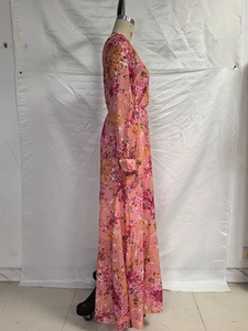 Close-up of floral maxi dress with button cuffs and high-waisted bohemian print details