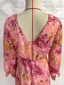 Detail of floral print chiffon dress featuring pink patterns and elastic waist design